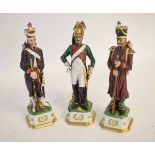 Three Capodimonte models of soldiers decorated in colours, raised on square plinths each measuring