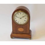 Early 20th century mahogany and boxwood line inlaid mantel timepiece, the arched case on plinth base