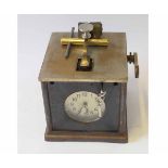 Early 20th century portable time recording timepiece, the iron and silvered brass square case with