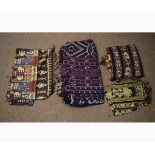 Bag containing four assorted woven fabric Indian wall hangings in geometric designs
