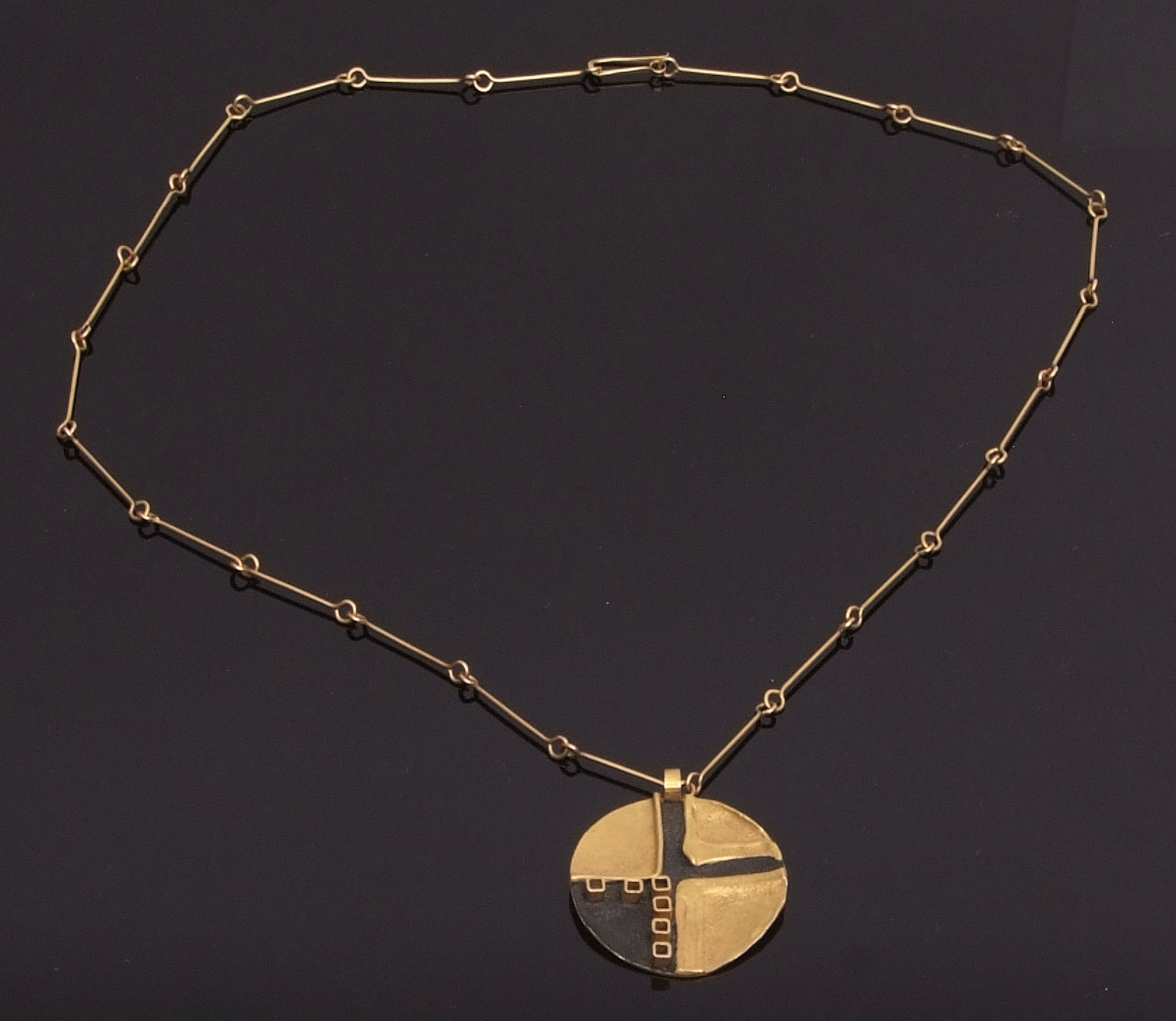 Italian circular disc pendant and chain, circa 1970, an abstract design by Atelier des Orfeveres,