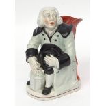 An early 19th century pearlware group of the Night-watchman seated holding his hat in one hand