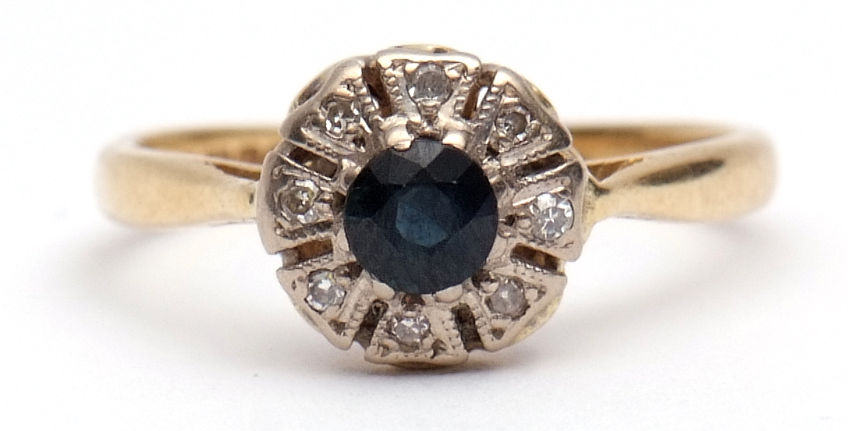 Sapphire and diamond cluster ring, the circular shaped sapphire surrounded by 8 small diamond set