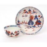 Lowestoft teabowl and saucer, circa 1780, painted in blue and red enamel with the doll's house