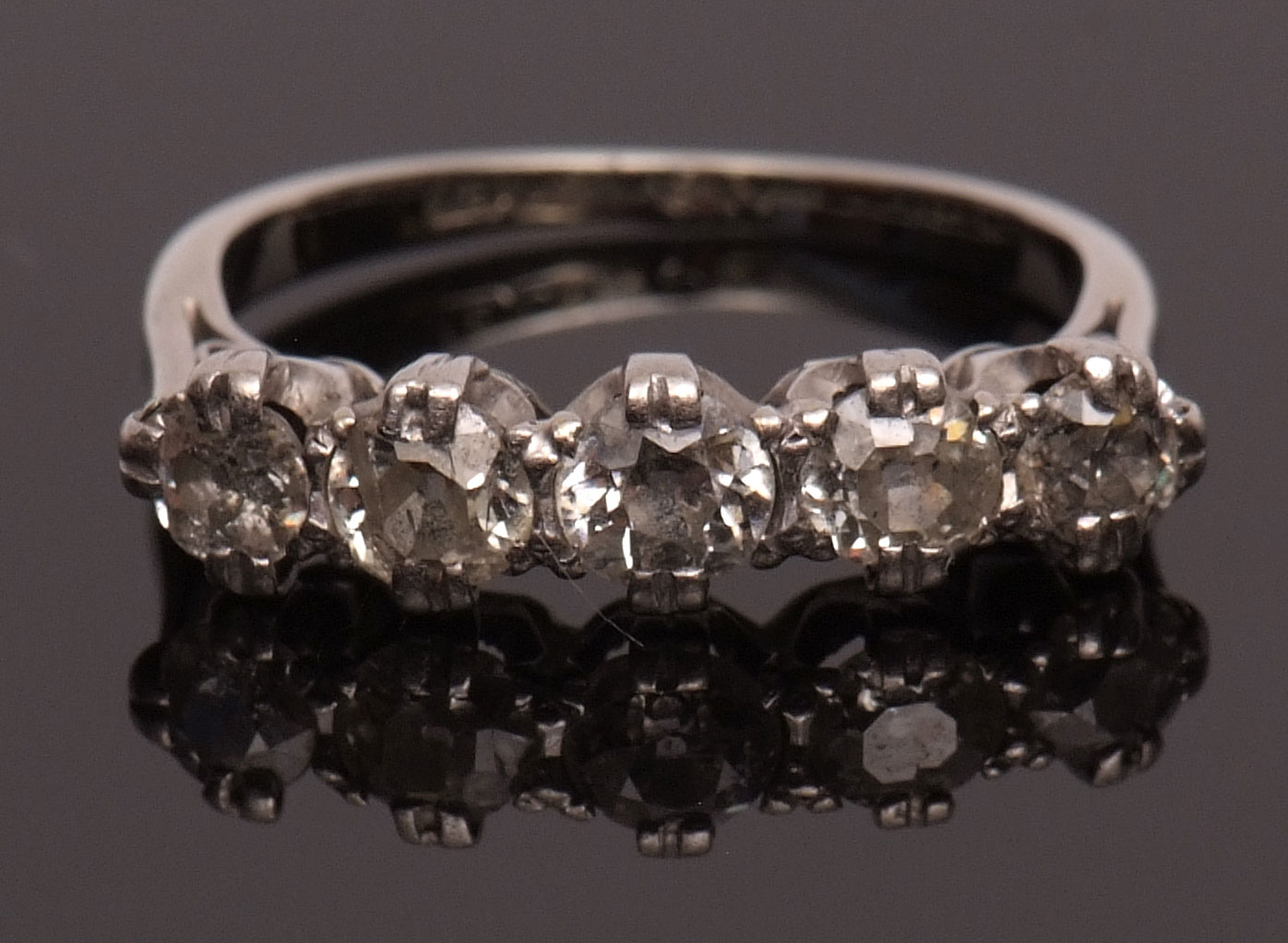 Precious metal five-stone diamond ring, line set with five single cut diamonds, approx 0.60ct, all