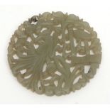 Chinese carved celadon jade pendant disc with phoenix amidst foliage, 5.8cm wide