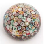 Millefiori paperweight inset with multi-coloured radiating cane design, 8cm diameter