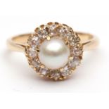 Antique pearl and diamond cluster ring featuring a single cultured pearl surrounded by 12 small