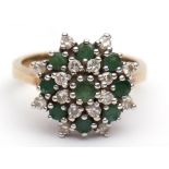 Modern yellow metal emerald and diamond cluster ring, having 9 circular-shaped small emeralds