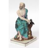 Early 19th century pearlware figure of Elijah being fed by a raven on a square base with brown