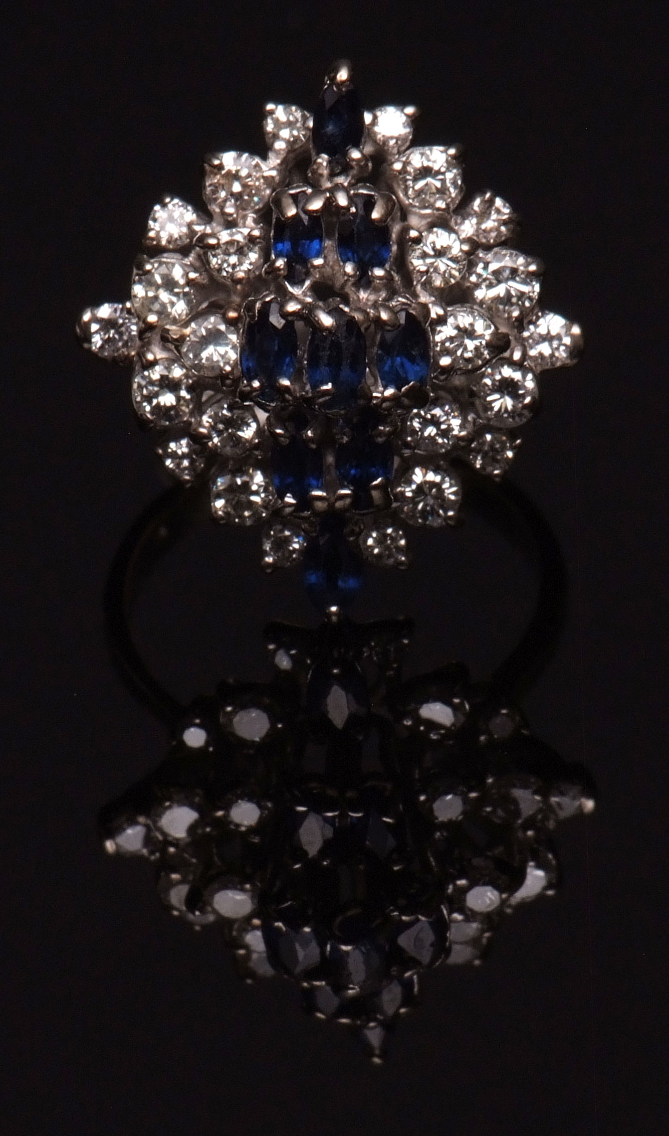 18ct white gold sapphire and diamond cluster ring, the tiered centre set with nine oval shaped