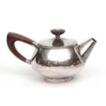 Elizabeth II bachelor's teapot, the spot hammered body with pull off cover fitted with a bladed