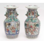 Pair of Canton style Chinese porcelain vases decorated in famille rose enamels with typical panels