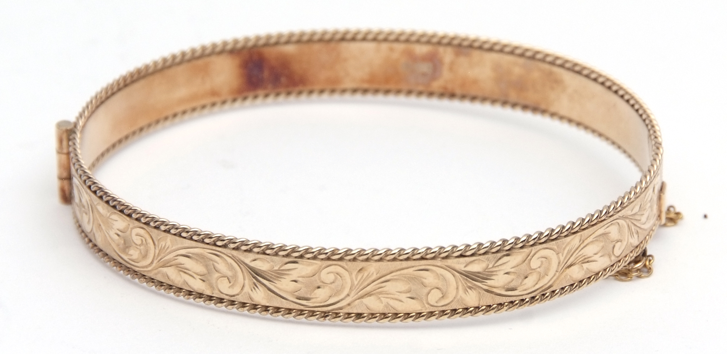 9ct gold hinged bracelet, part engraved and chased with a foliate design, makers mark Cropp &