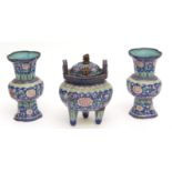 Chinese Canton enamel garniture comprising a censer and two en-suite vases, decorated with scrolling