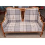 Edwardian two-seater cottage sofa with central pierced splat, coloured checked upholstery on