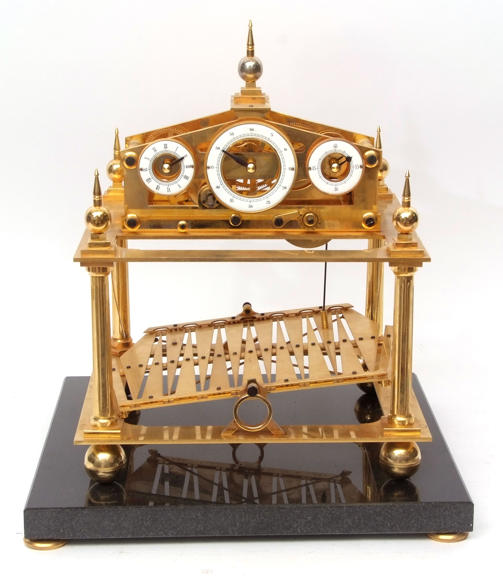 20th century Congreve type rolling ball timepiece, the lacquered brass case comprising four columns,