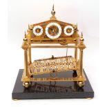20th century Congreve type rolling ball timepiece, the lacquered brass case comprising four columns,