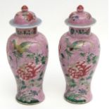 Pair of Chinese porcelain lidded jars decorated in famille rose enamels with peony and butterflies