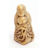 Japanese ivory netsuke of a standing Sennin holding a large peach spray, possibly late 18th century,