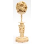 Chinese ivory puzzle ball carved with writhing dragons amidst clouds, on an ivory immortal stand,