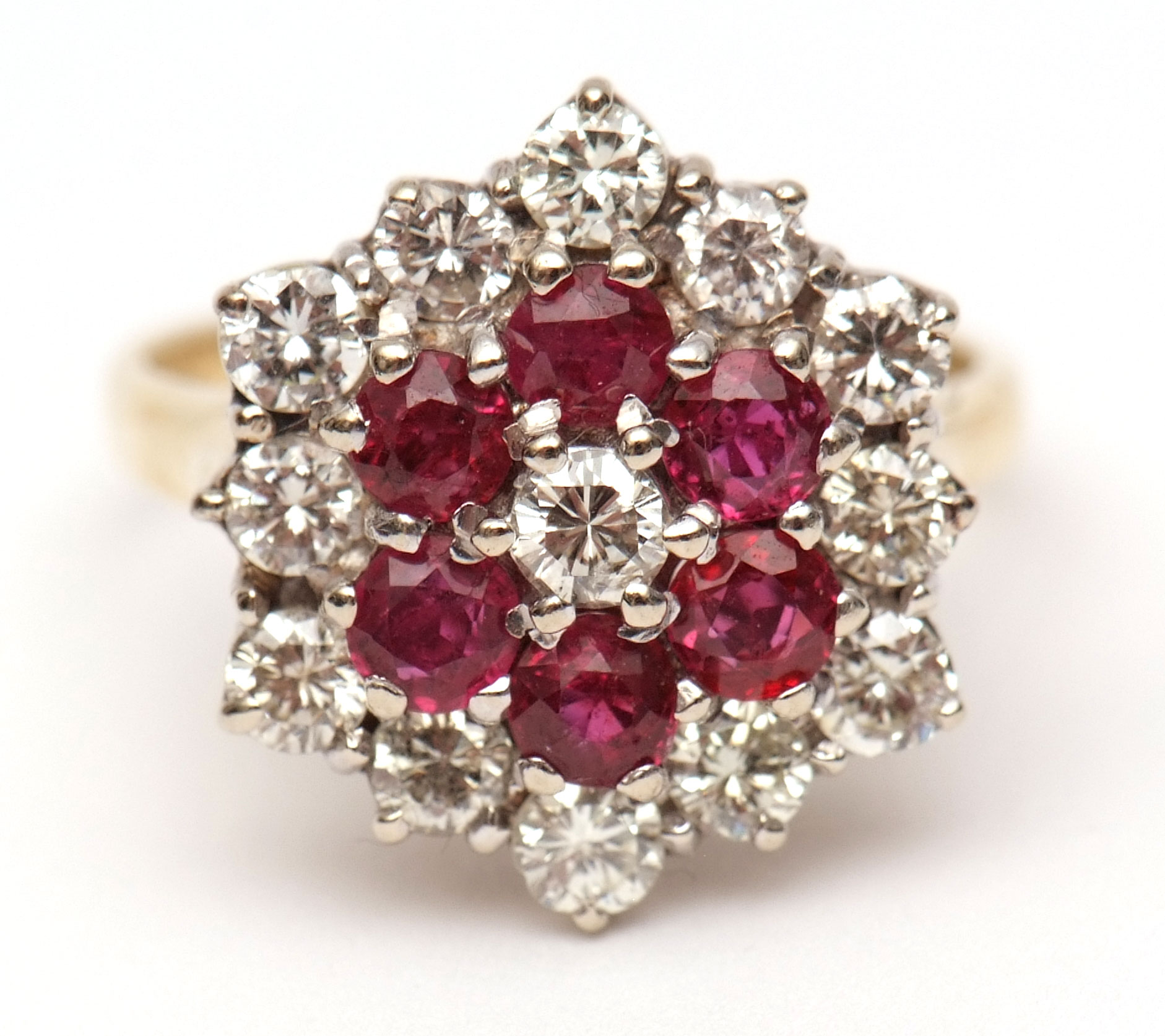 18ct gold diamond and ruby cluster ring, the centre a brilliant cut diamond raised within a surround