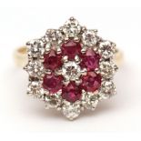 18ct gold diamond and ruby cluster ring, the centre a brilliant cut diamond raised within a surround