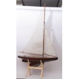 Early 20th century varnished timber pond yacht with typical weighted hull and fitted with mast, boom