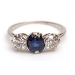 Precious metal sapphire and diamond three-stone ring, the cushion-shaped sapphire is set between two