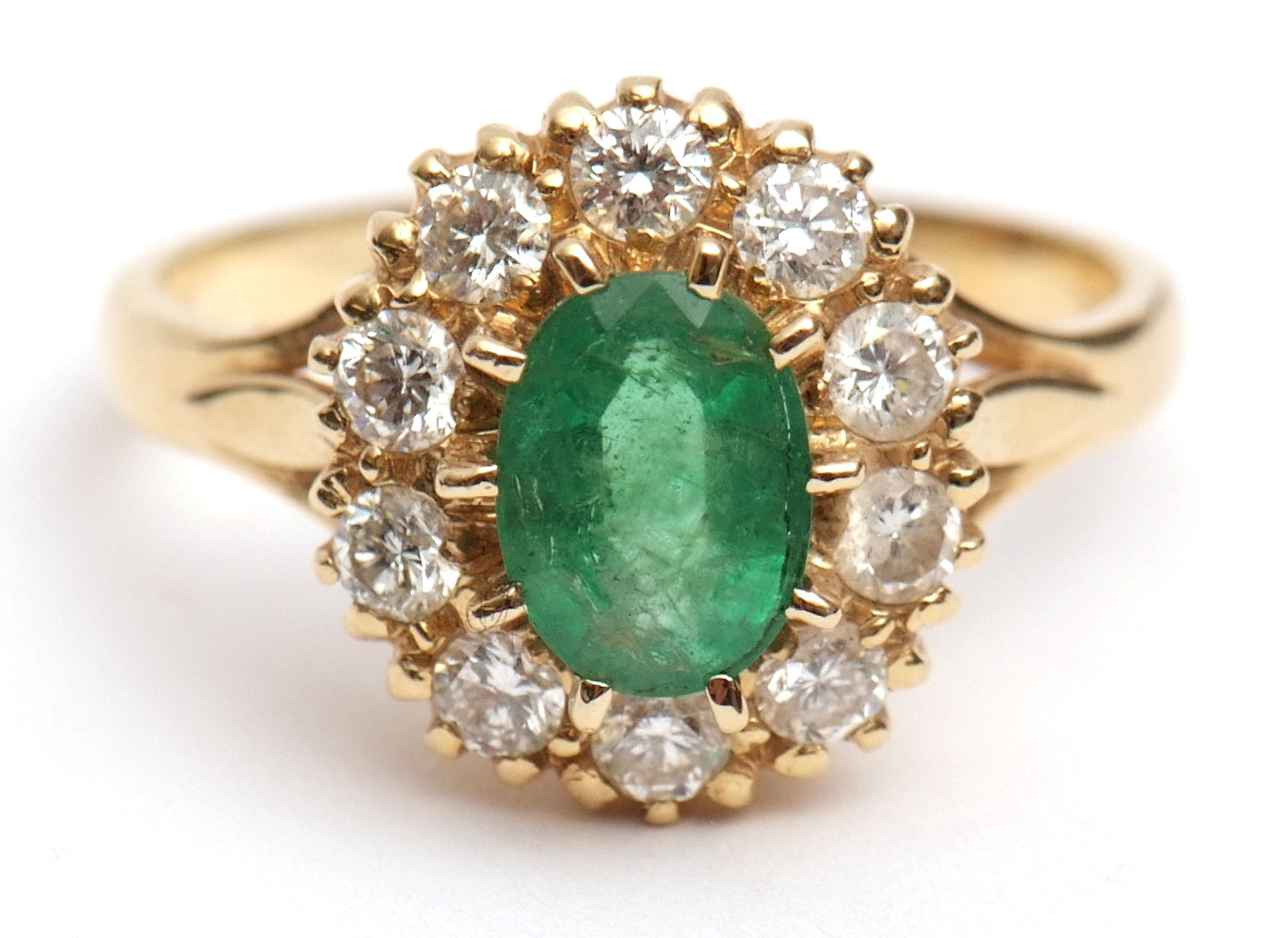 Mid-20th century 18ct gold emerald and diamond cluster ring, the oval cut emerald (8mm x 5mm approx)