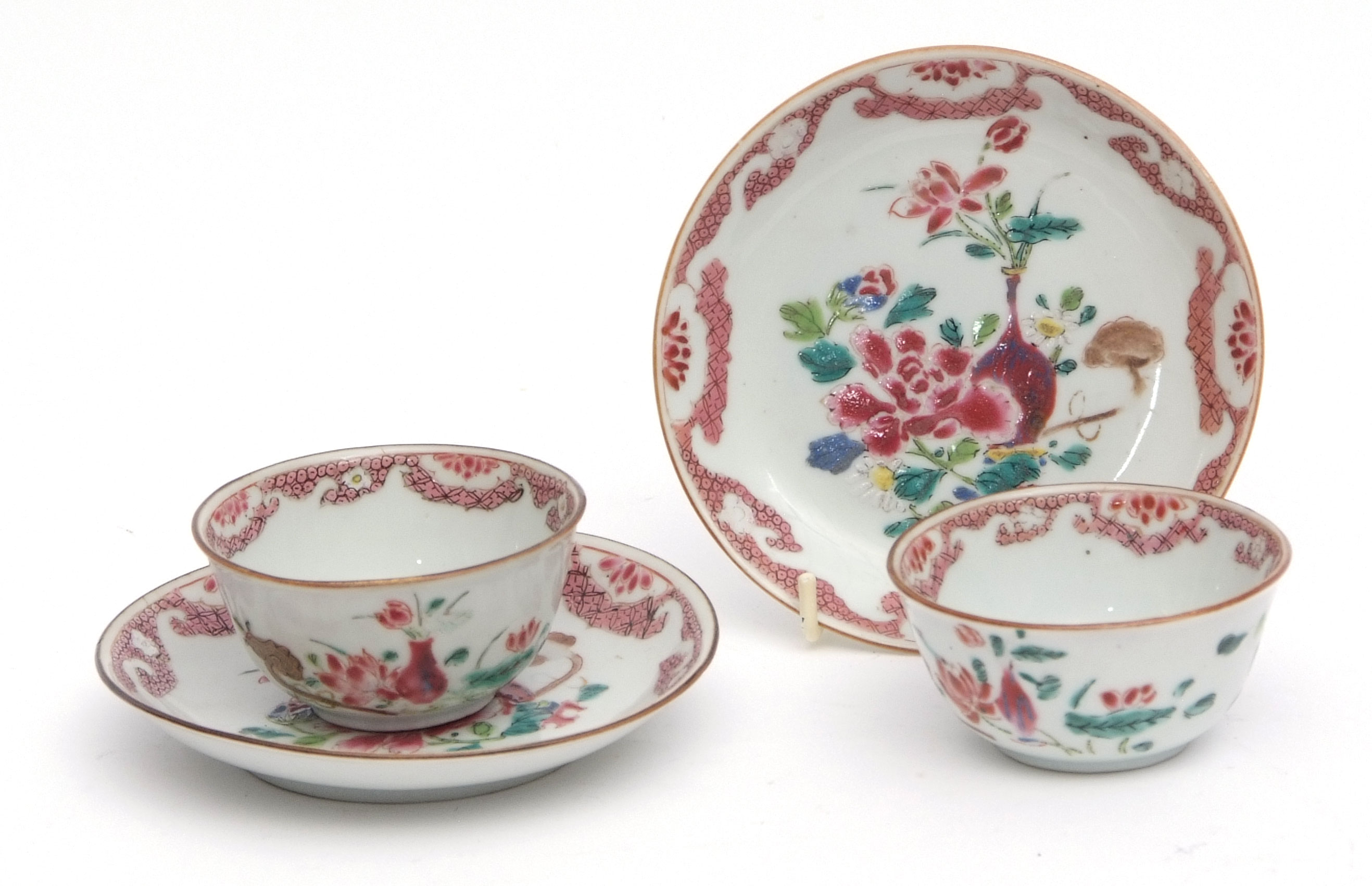 Pair of Chinese famille rose porcelain tea bowls and saucers, decorated with floral displays,