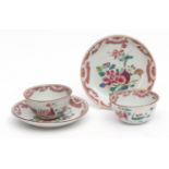 Pair of Chinese famille rose porcelain tea bowls and saucers, decorated with floral displays,