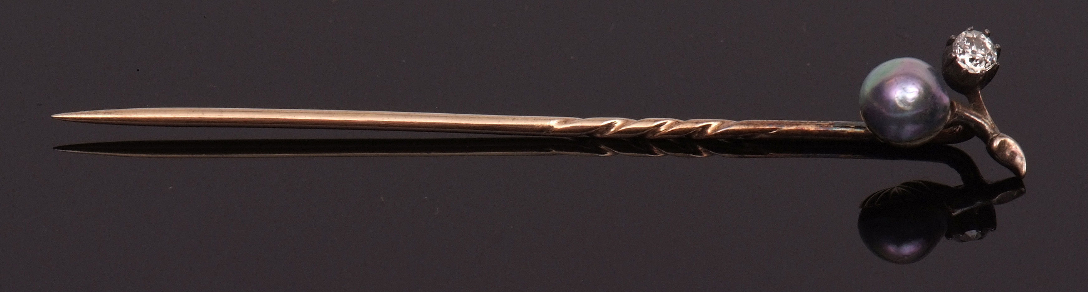 Edwardian grey pearl and diamond "sprig" tie-pin, the sprig set with a grey split pearl, 5mm