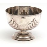 Late Victorian rose bowl of polished circular form with half wrythen fluted body on a spreading