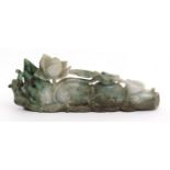 Chinese mottled green jade brush rest carved as lotus amidst waves, 11cm long