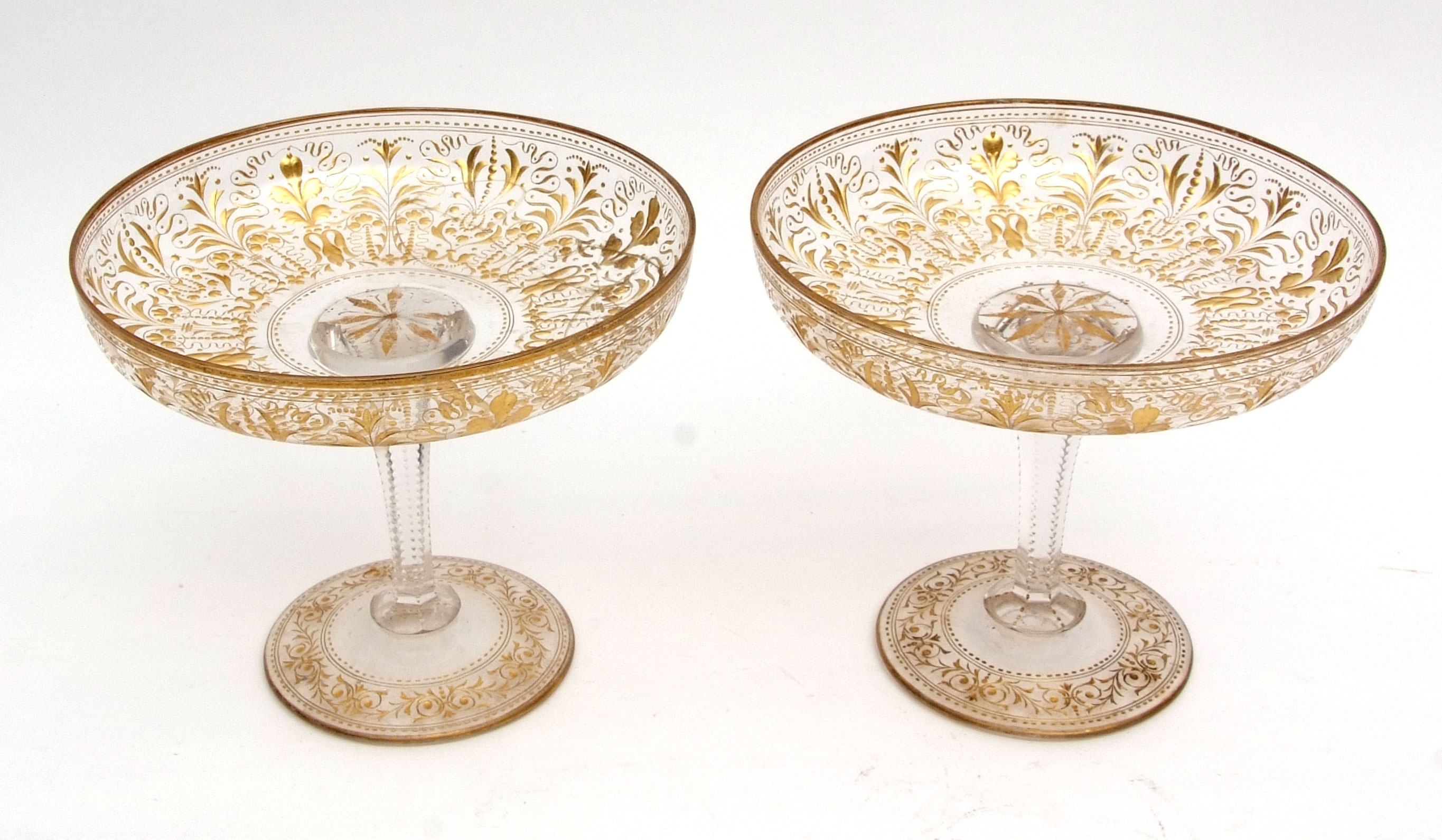 Pair of gilded glass tazzas, well gilded with neo-classical designs throughout, raised on tapering