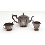 George V three-piece tea set comprising tea pot, sugar basin and milk jug, each of faceted