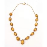 Citrine mounted riviere necklace, mounted with graduated oval shaped citrines in coronet mounts, all