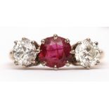 Precious metal ruby and diamond three-stone ring, the circular cut ruby 0.73ct (est) between two old