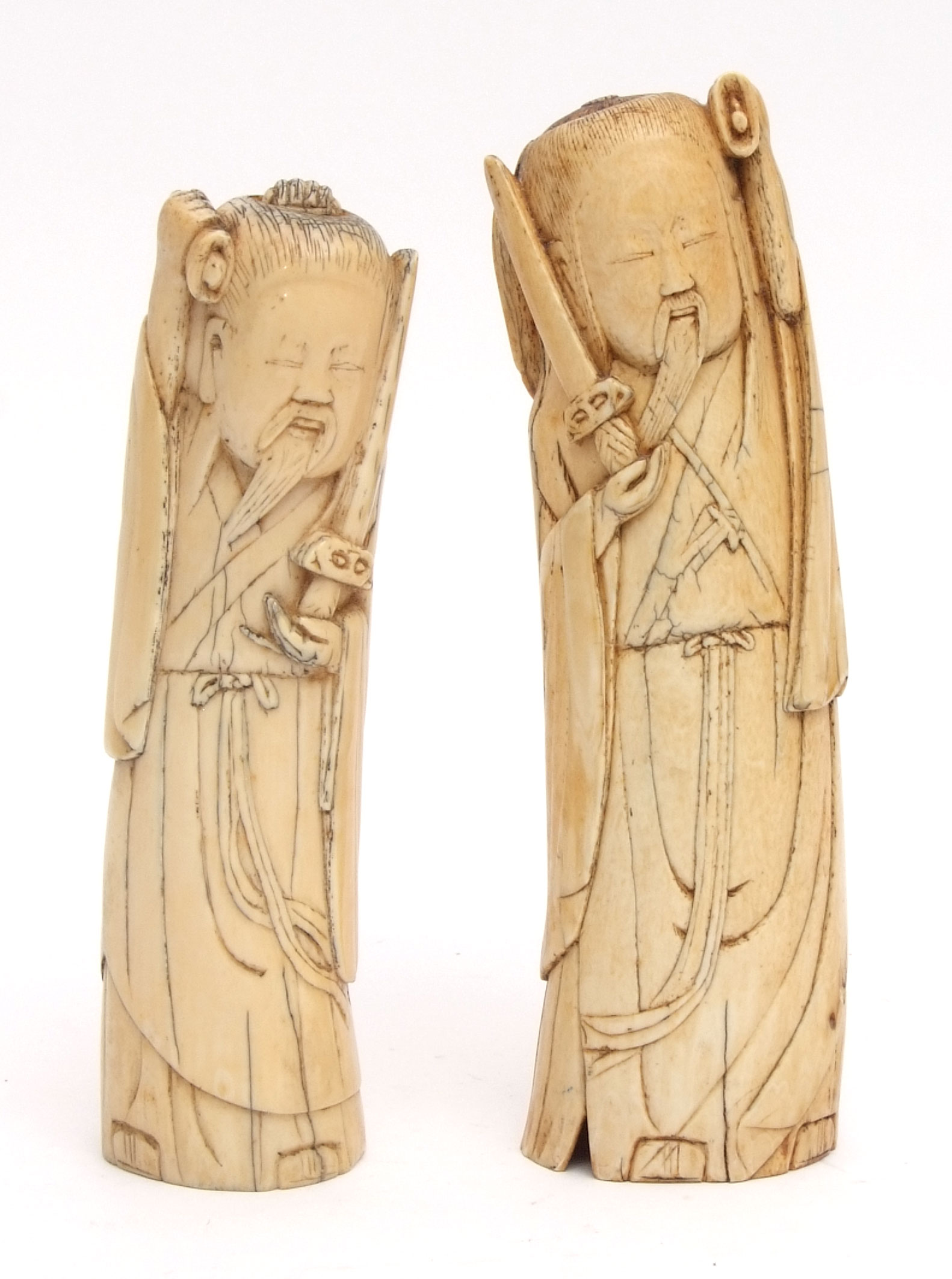 Two Chinese ivory carvings of immortals, 19 1/2cm high and 18cm high