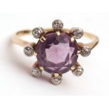 Precious metal amethyst and diamond ring, the circular-shaped amethyst is within a surround of 8