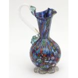 Millefiori small ewer with trefoil neck, clear glass handle and the body typically decorated with