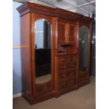 Edwardian break front wardrobe with moulded cornice, central cupboard over five drawers with open