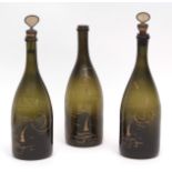Set of three 18th/19th century olive green glass spirit bottles, partial remaining gilt
