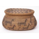 Tribal tightly woven oval and lidded basket, the pull off cover with replicating diamond design to a