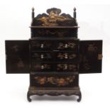 Japanese black and gold lacquer table cabinet on stand, with double doors enclosing six drawers with