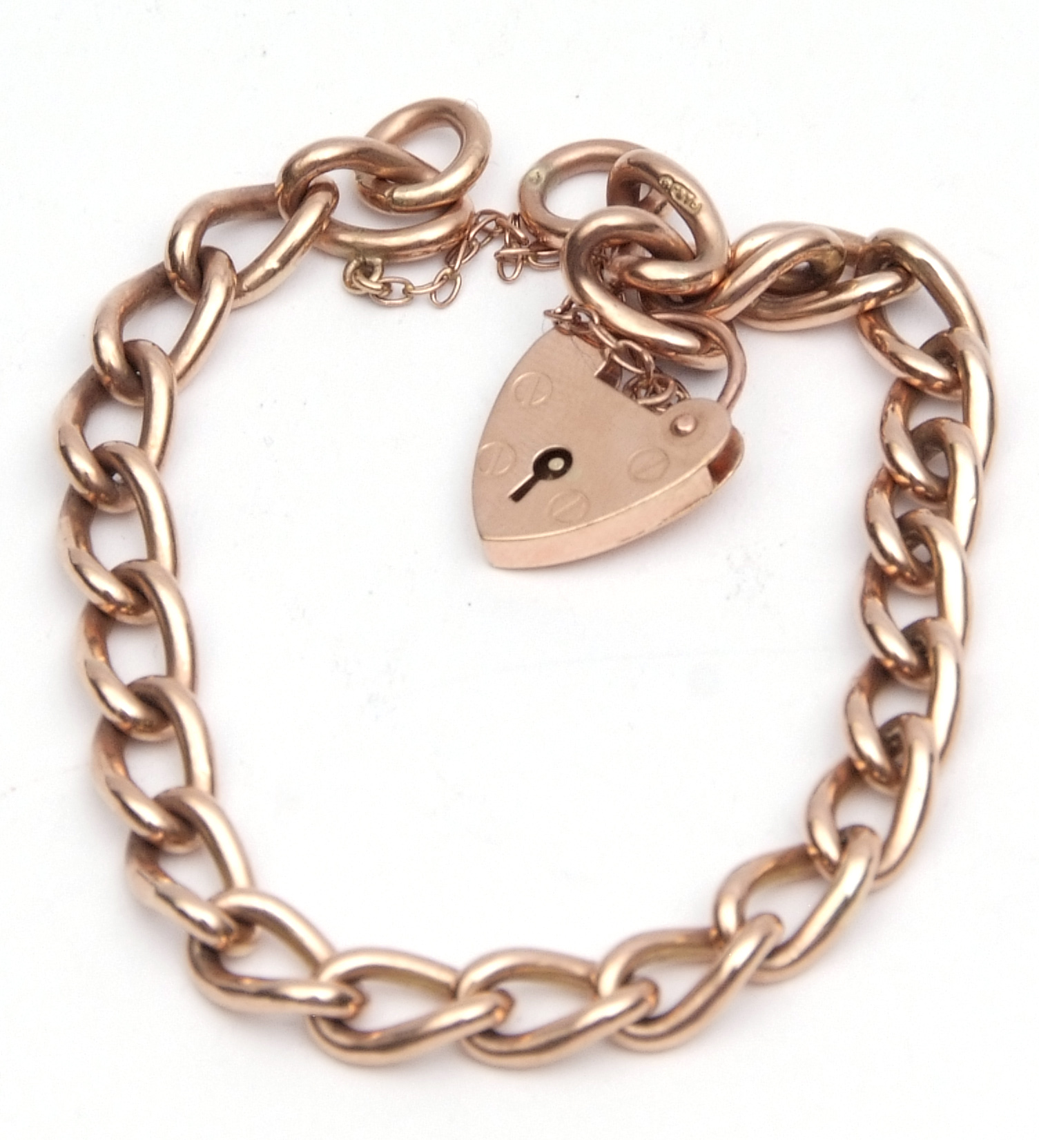 9ct rose gold curb link bracelet, with heart shaped padlock and safety chain fitting, 24.7gm