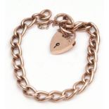 9ct rose gold curb link bracelet, with heart shaped padlock and safety chain fitting, 24.7gm
