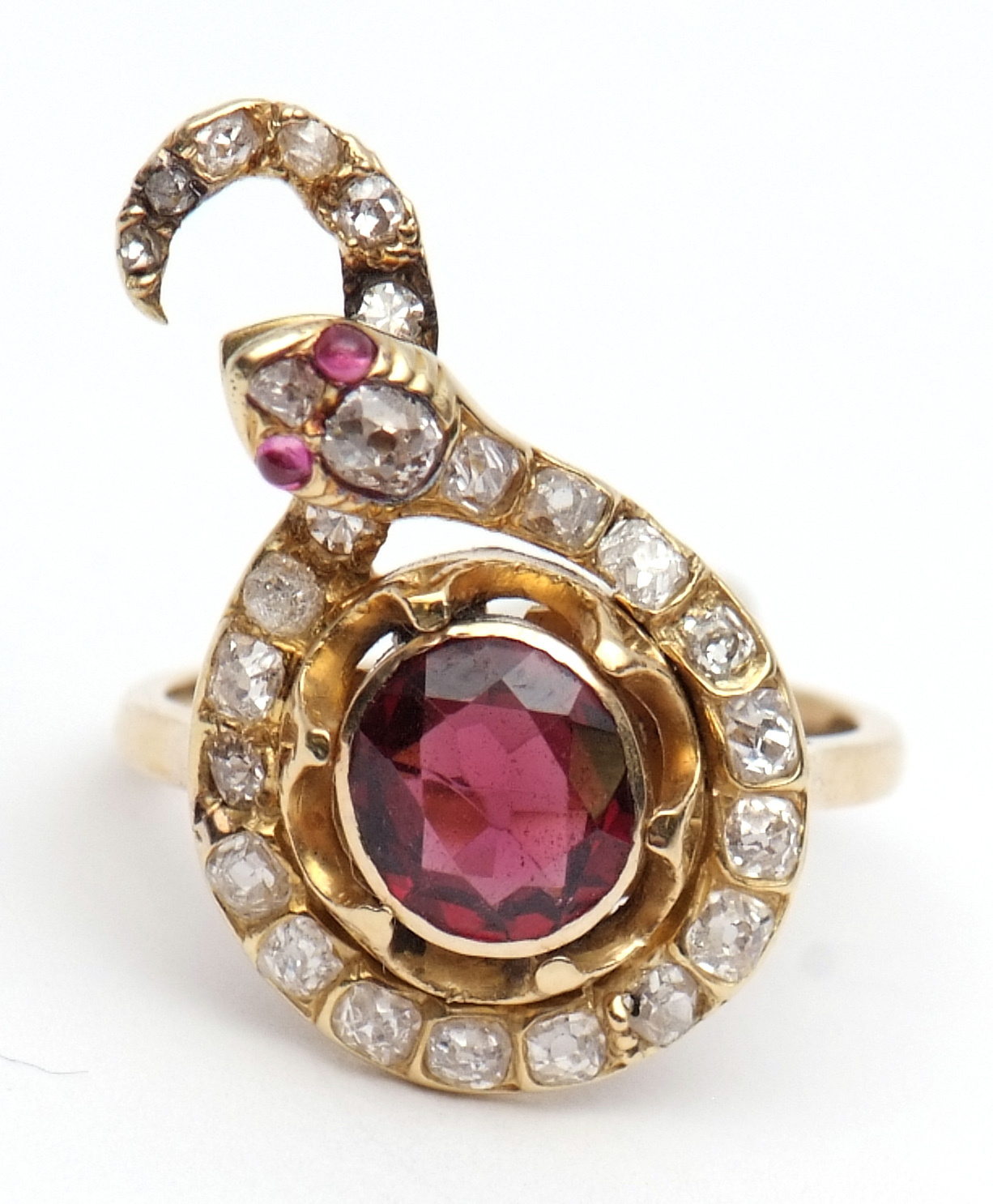 Ruby and diamond snake ring, the centre having an oval shaped ruby with a diamond set coiled body