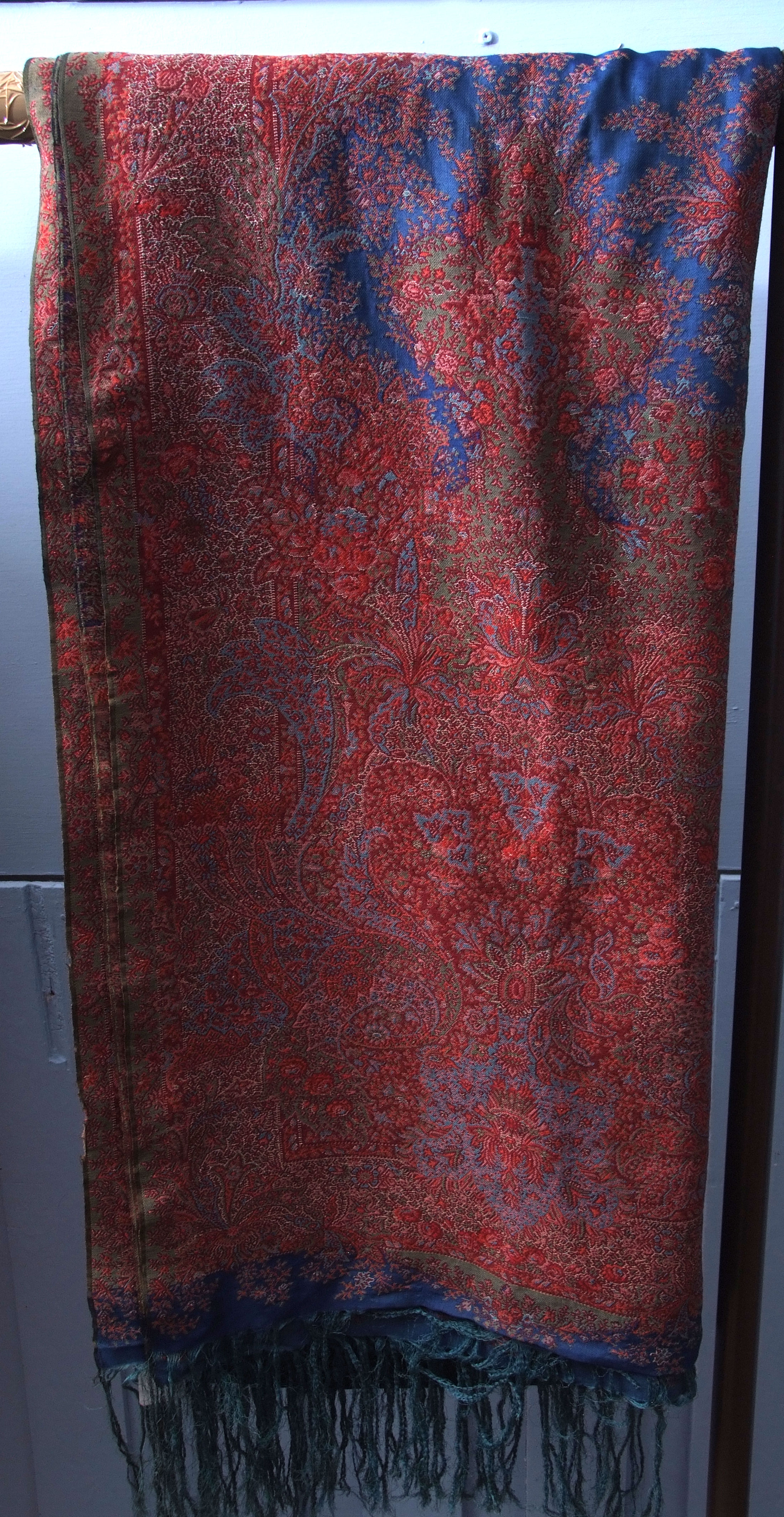 Late 19th century Norwich Paisley shawl, on a predominantly blue silk background with red, blue